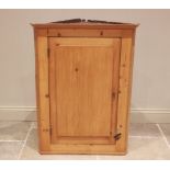 A Victorian pine straight front hanging corner cupboard, the single door opening to two shelves,