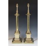 A pair of brass Corinthian column table lamps, each cast with a plain column upon a wreath collar