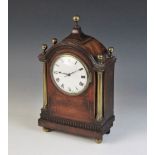 A Regency style mahogany cased mantel timepiece, early 20th century, the arched case with