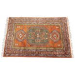 A Persian style sienna ground rug, the central octagonal medallion flanked by geometric gulls,