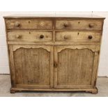 A George III mahogany estate cupboard, formed from four small drawers over two cupboard doors and