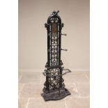 A Victorian Coalbrookdale style hall stand, the reeded arched frame extending to five oak leaf and