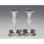 A pair of late Victorian silver candlesticks, William Devenport, Birmingham 1900, each with plain