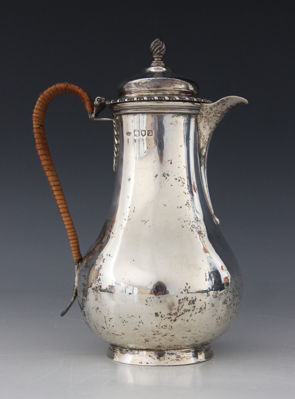 A George V silver hot water jug, John Henry Rawlings, London 1911, of baluster form on raised