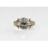 A 19th century diamond floral cluster ring, comprising a central oval old cut diamond measuring 5.