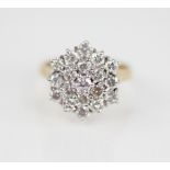 A diamond cluster ring, designed as a tiered hexagonal cluster of nineteen round brilliant cut