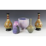 A contemporary studio pottery footed vase by Clive Bowen, glazed in purple and lavender tones over a