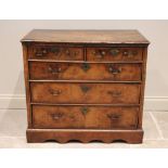 A George I and later walnut chest of drawers, the rectangular moulded top over two short and three