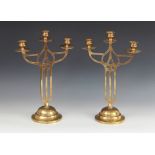 A pair of early 20th century brass Art Nouveau candelabra in the Mackintosh style, each with three