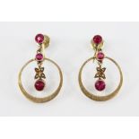 A pair of Edwardian ruby and pearl set 15ct gold earrings, each designed as a round mixed cut ruby