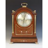 An Edwardian mahogany cased bracket clock, the arched case with a brass swing handle and sphere