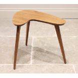 A mid 20th century teak boomerang table, the elongated shaped top raised upon three legs of tapering
