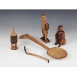A selection of tribal carvings to include two South African Zulu figures, two wooden Zulu spoons and