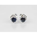 A pair of sapphire 18ct gold stud earrings, each comprising a round mixed cut sapphire measuring 4.