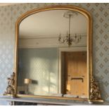 A large Victorian giltwood and gesso framed over-mantel mirror, the arched single mirror plate