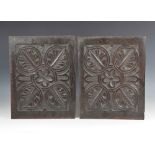 A pair of 17th century carved oak panels, each carved with a central flower head roundel enclosed by