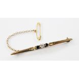 A diamond and sapphire 18ct gold bar brooch, the central round brilliant cut diamond weighing