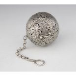 A Chinese silver coloured incense ball, of spherical hinged form with pierced and incised foliate