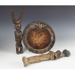 A West African Nigerian Yoruba divination board, 22cm diameter, a Yoruba figure, 31.5cm high, and