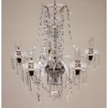 An early 20th century glass chandelier, the reeded baluster stem extending to five 'S' shaped barley