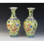 A pair of Chinese porcelain famille jaune vases, Kangxi mark (20th century), of begonia form (