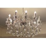 A large 20th century French style crystal chandelier, the central baluster stem extending to