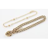 A 9ct gold curb link bracelet, 18cm long, with a 9ct gold heart-shaped padlock fastener, 19mm x