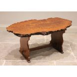 A mid 20th century yew wood coffee table in the manner of Reynolds of Ludlow, the rough cut slab top