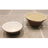 Two late 19th/early 20th century French glazed stoneware dairy bowls, each of typical conical form