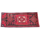 An Iranian red ground floor runner, the central medallion set to a red panel extending to