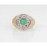 An emerald and diamond 14ct gold target ring, the central circular cluster designed as a circular