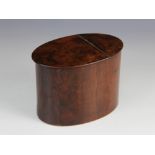 A George III walnut tea caddy, of plain polished oval form with hinged cover, silvered paper lining,