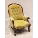 A Victorian mahogany framed tub style drawing room chair, the arched button back extending to padded