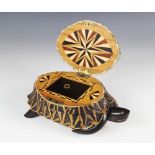 An early 20th century Indian star tortoise tea caddy, the hinged cover opening to a parquetry inlaid