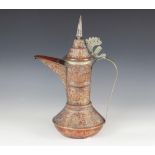 An Arabic embossed copper coffee pot (Dallah), decorated with foliate motifs throughout, with