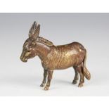 A late 19th century novelty brass tape measure, modelled as a donkey with fur effect chasing,