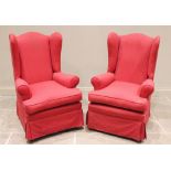 A pair of George III style wing back fireside armchairs, early 20th century, later re-covered in red