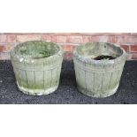 A pair of reconstituted stone planters formed as coopered buckets, 32cm high, along with a third