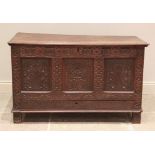 A late 17th/early 18th century carved oak mule chest, the hinged moulded board top above three