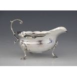 A George III silver sauce boat, possibly William Skeen, London 1773, of typical from with shaped rum