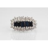 A sapphire and diamond cluster ring, the central boat shaped cluster comprising five graduated