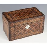 A late 19th century walnut and parquetry tea caddy, the hinged top inlaid with repeating geometric