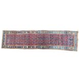 A Persian style blue ground hand knotted wool runner, the central panel extensively decorated with