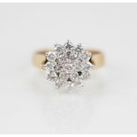 A diamond floral cluster ring, designed as a tiered cluster of nineteen round brilliant cut