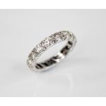 A diamond eternity ring, comprising seventeen round brilliant cut diamonds, each weighing