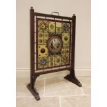 An early 20th century stained and leaded glass fire screen, the walnut frame enclosing the