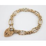 A 9ct gold gate-link bracelet with a heart-shaped padlock fastener, bracelet 18cm long, padlock