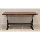A Victorian cast iron table, the rectangular hardwood top raised upon cast Aesthetic Movement type