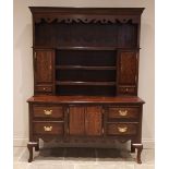 A George III style oak and mahogany crossbanded dresser, early 20th century, the high back with a