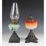 A Victorian oil lamp, the coral coloured glass reservoir moulded in relief with thistles, raised